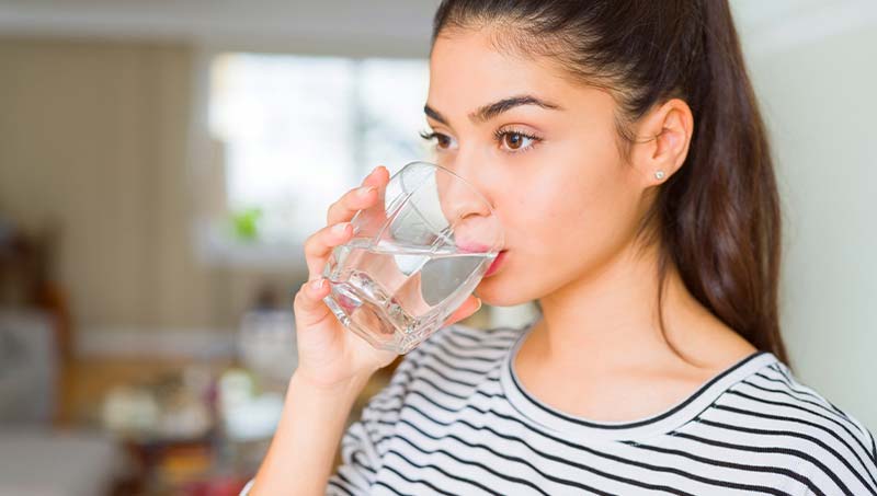 patient drinking more water following the advice of a Irvine Chiropractor at DiSiena & Irvine Chiropractic, Brain Wellness, and Nutrition