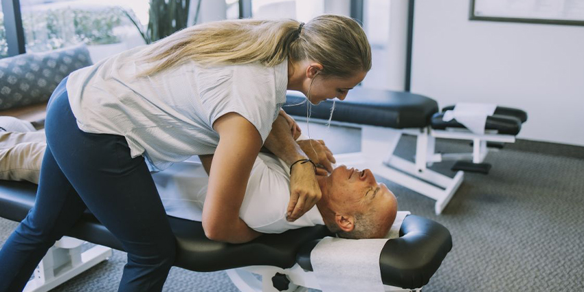 Irvine chiropractor at DiSiena & Irvine Chiropractic, Brain Wellness, and Nutrition adjusting patient's shoulder to relieve pain