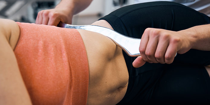 patient getting graston treatment in Irvine, CA